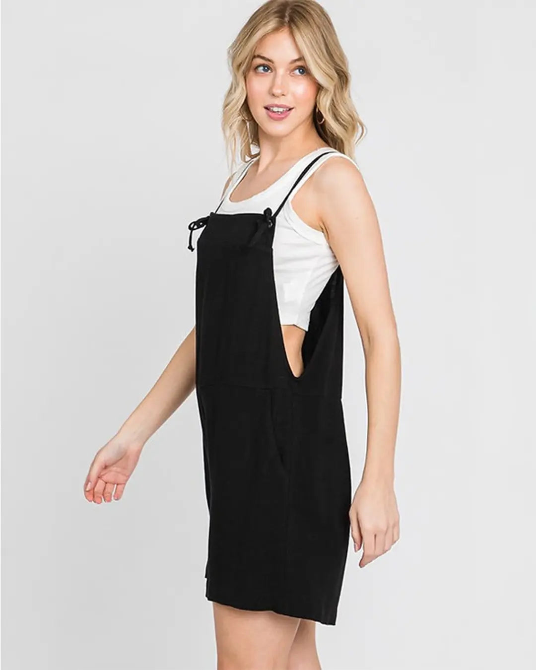 Gorgeous pull on jumper featuring adjustable spaghetti straps, front pockets, loose silhouette with dramatic wide legs in a soft light weight fabrication.