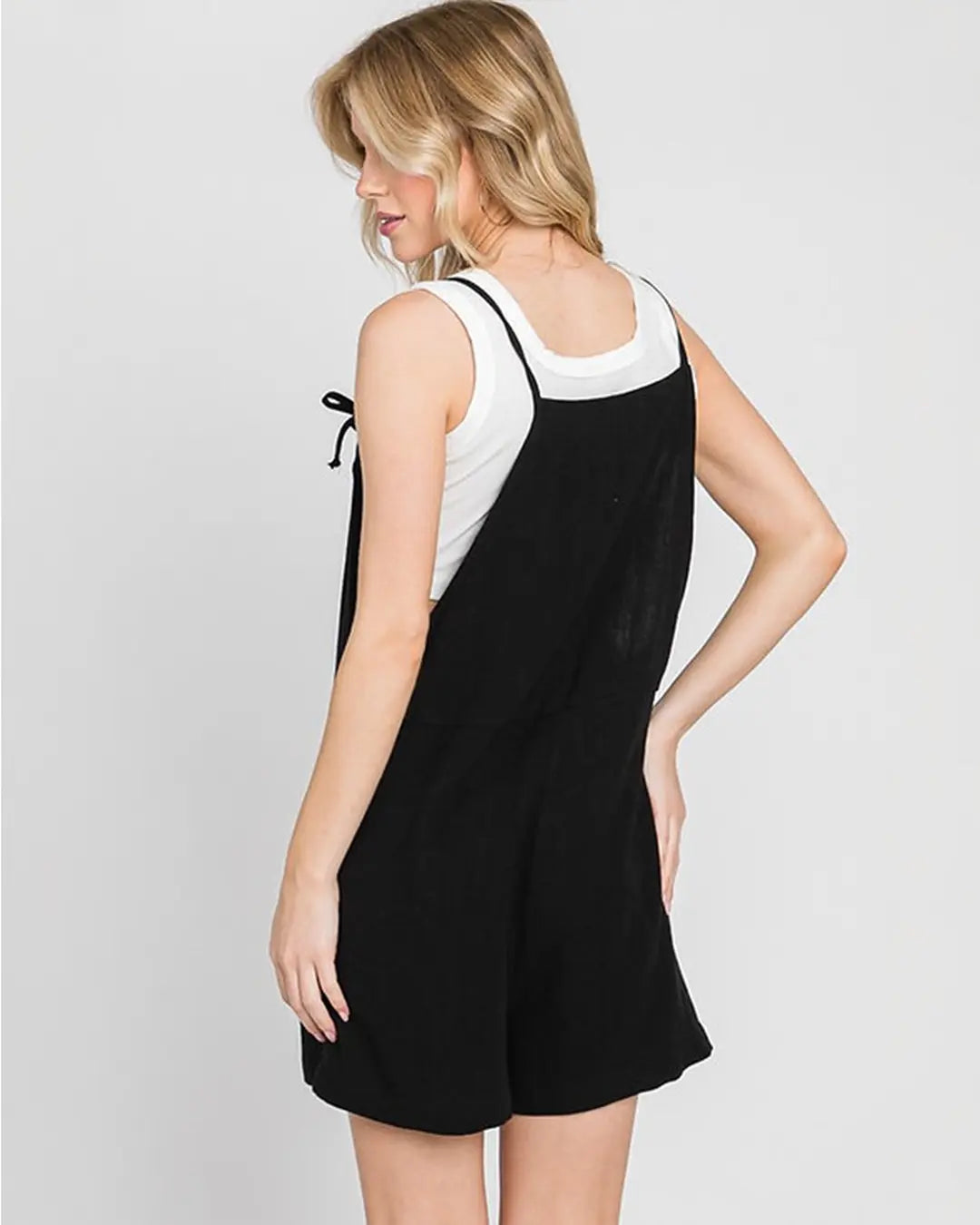 Gorgeous pull on jumper featuring adjustable spaghetti straps, front pockets, loose silhouette with dramatic wide legs in a soft light weight fabrication.