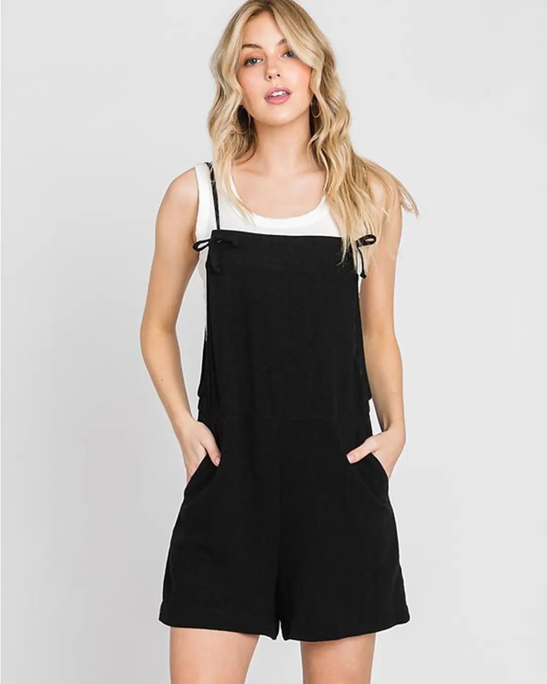 Gorgeous pull on jumper featuring adjustable spaghetti straps, front pockets, loose silhouette with dramatic wide legs in a soft light weight fabrication.