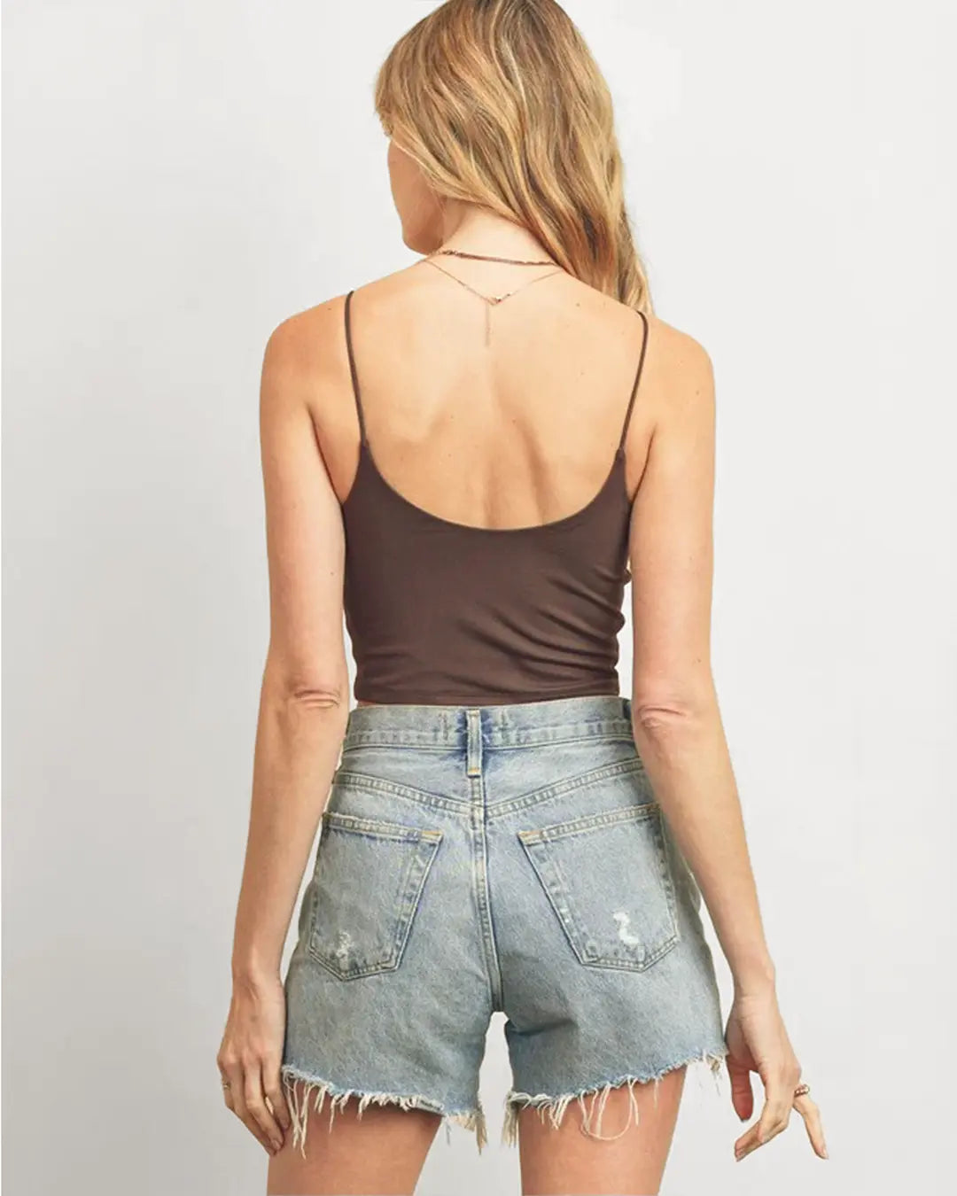 Elevate your summer style with our supportive Double Layered Crop Top, featuring double scoop necklines and elastic cord straps for a comfortable fit. Crafted from a blend of 97% polyester and 3% spandex, it offers both style and stretch for all-day wear.