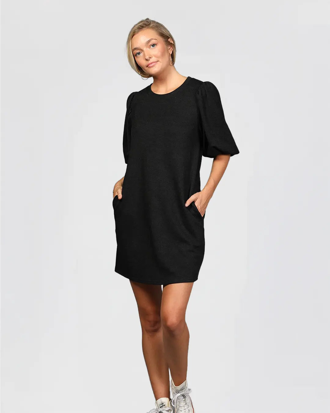 Elevate your wardrobe with our Ribbed Round Neck Knit Dress, boasting short balloon sleeves, convenient front slanted pockets, and a chic mini length. Crafted from high-quality 100% polyester, this dress offers both style and comfort for any occasion.