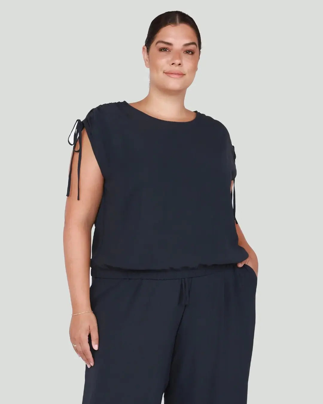 Elevate your casual chic look with our Drawstring Shoulder Midnight Navy Top, featuring stylish drawstring shoulders for added flair. Crafted with attention to detail and versatility in mind, this top is a must-have staple for any wardrobe.