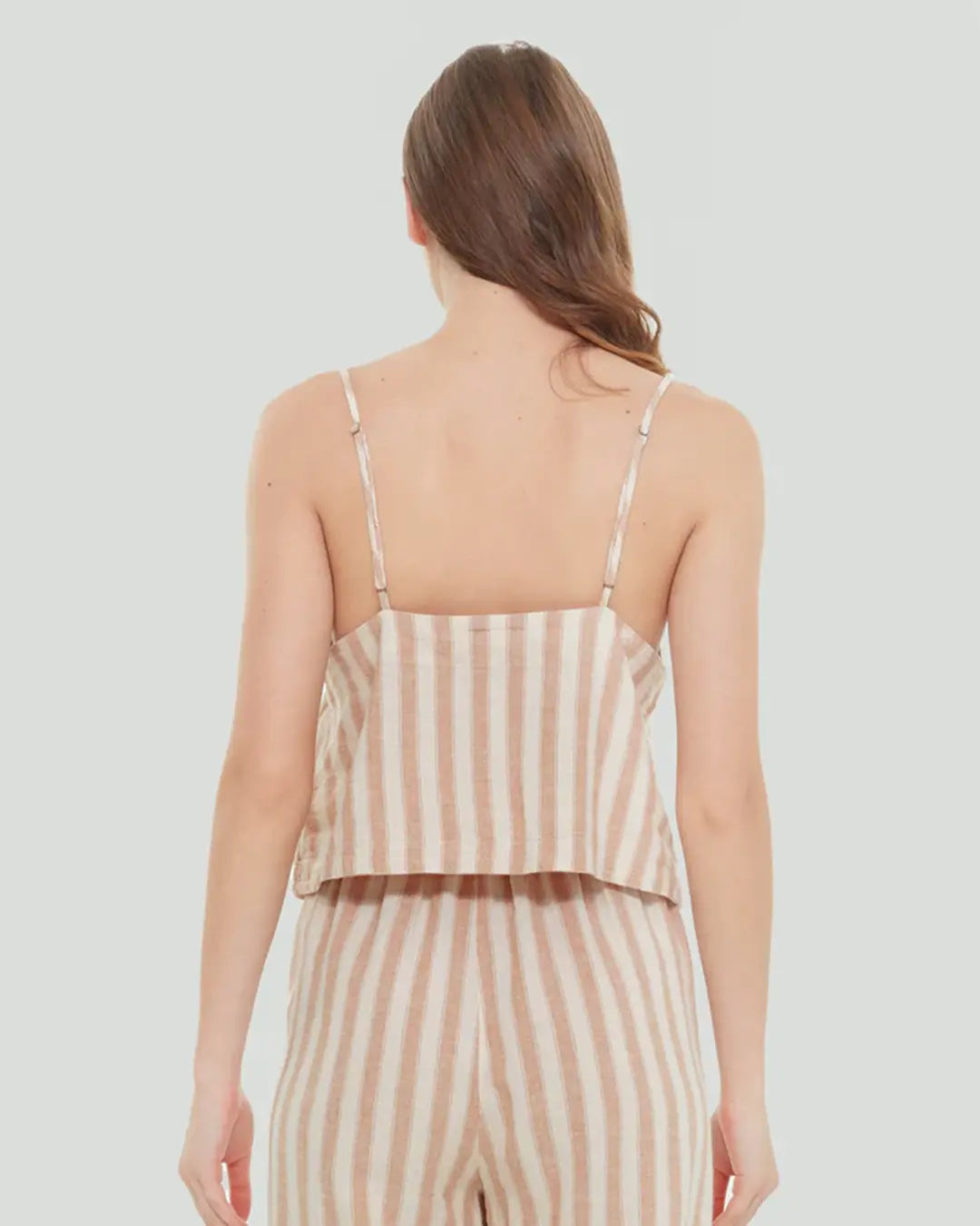 Discover a subtly fashionable look with our Striped Cami. Crafted in airy linen fabric, this cami features a v-neckline, adjustable spaghetti straps, and a full button front, all rendered in a timeless taupe stripe to complete your summer wardrobe.