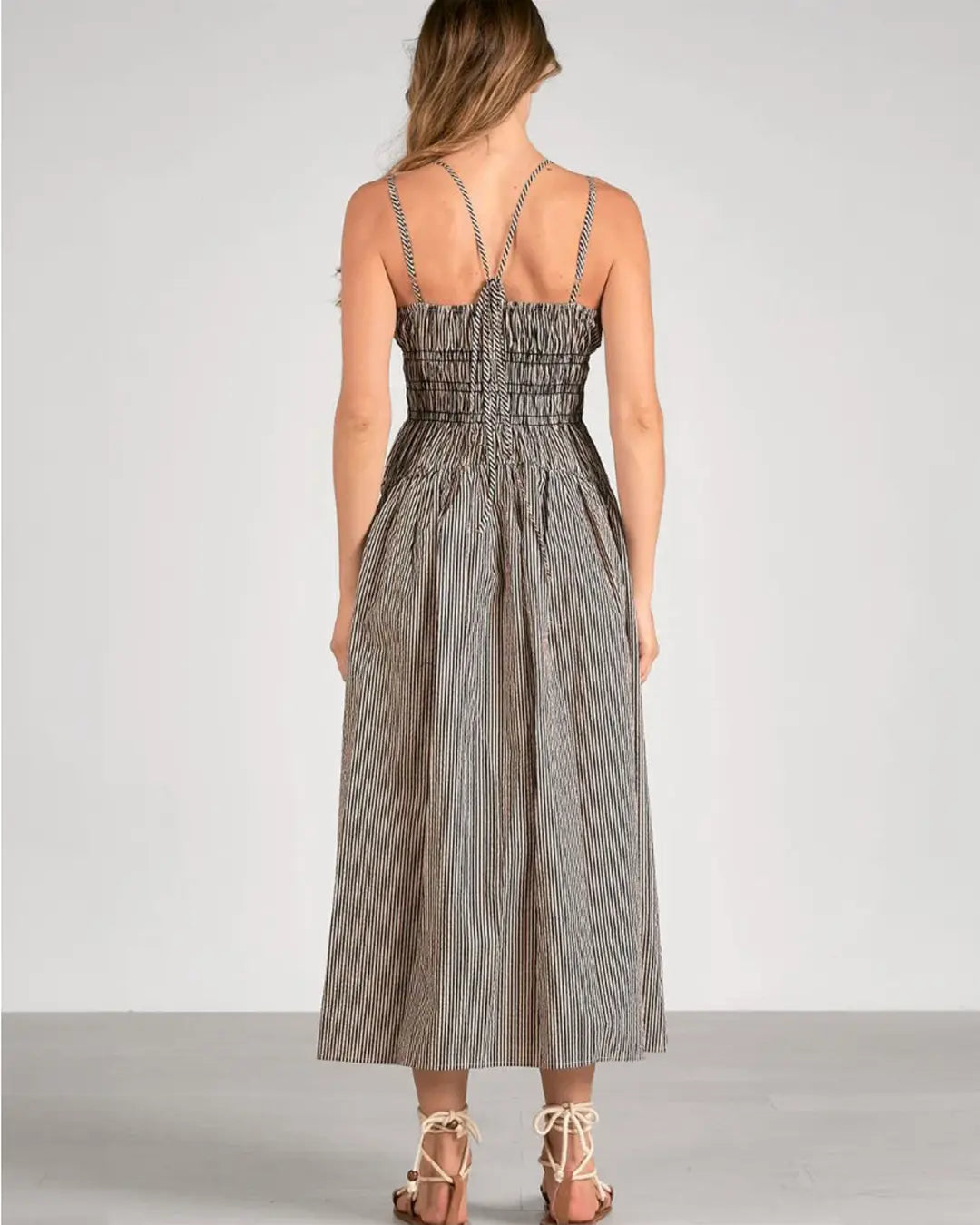 Indulge in the timeless elegance of the Blaire Maxi Dress. The flattering vertical striping and chic multi-wear straps make this dress perfect for any summer occasion. Its black and off-white color combination exudes sophistication and class.&nbsp;