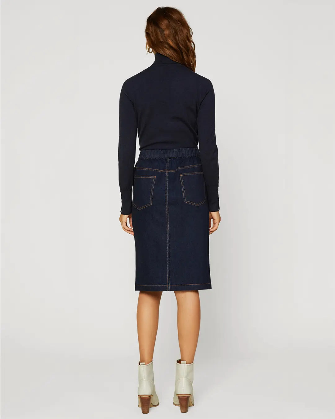 A dark denim skirt is a classic piece that you can wear season after season. This version is especially lustworthy in a curve-enhancing silhouette with a trail of buttons down the front. Wear it with your favorite tee or tank when it’s warm out, then add a cozy sweater when the temperature drops.