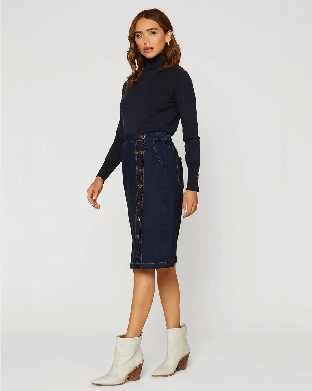 A dark denim skirt is a classic piece that you can wear season after season. This version is especially lustworthy in a curve-enhancing silhouette with a trail of buttons down the front. Wear it with your favorite tee or tank when it’s warm out, then add a cozy sweater when the temperature drops.