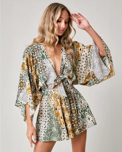 Channel your inner bohemian with our Boho Paisley Print Romper. With batwing sleeves and a tie front detail, this romper is both stylish and comfortable. Complete with side pockets and made from breathable fabrics, you'll feel super flattering and ready to rock those western vibes.