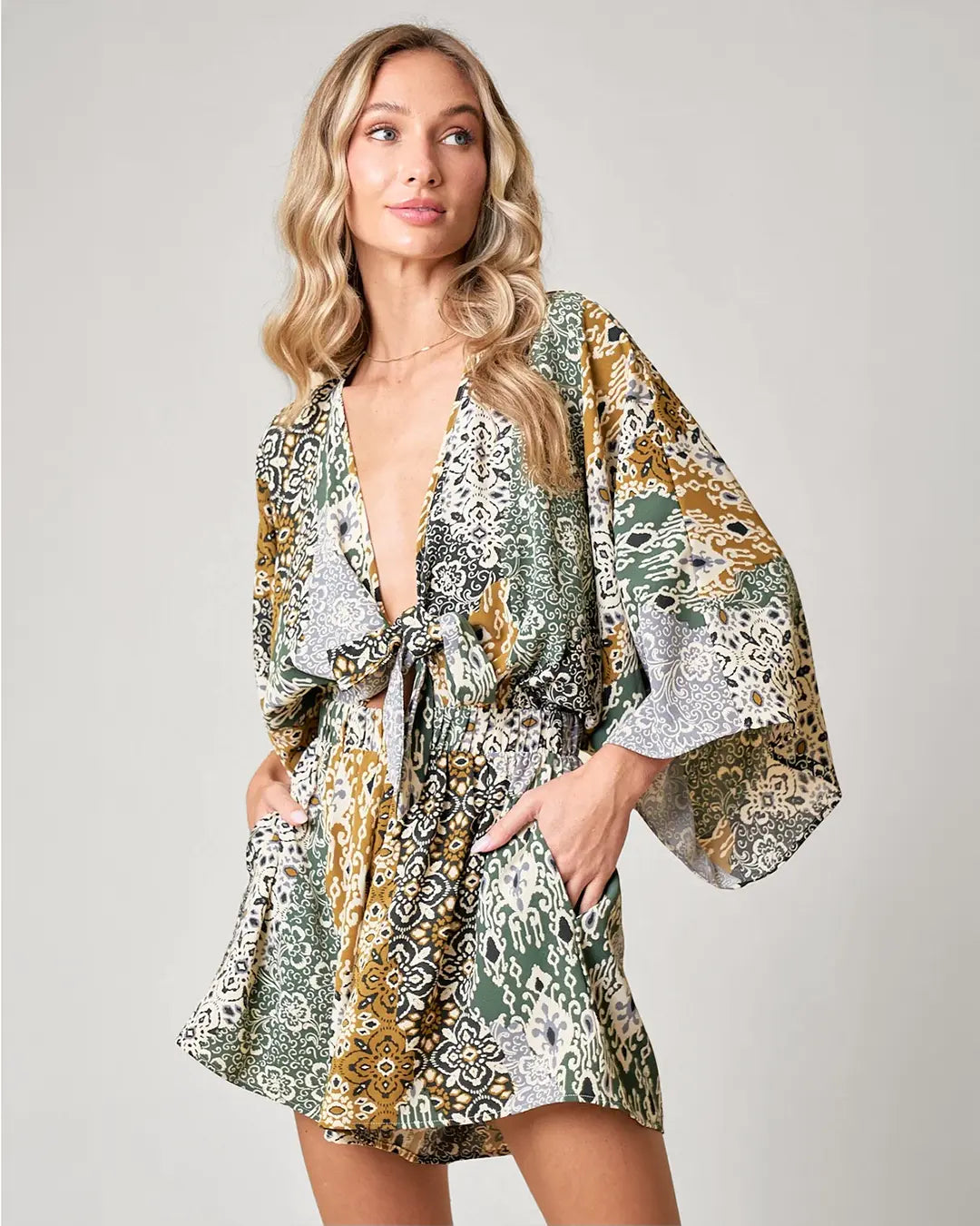 Channel your inner bohemian with our Boho Paisley Print Romper. With batwing sleeves and a tie front detail, this romper is both stylish and comfortable. Complete with side pockets and made from breathable fabrics, you'll feel super flattering and ready to rock those western vibes.